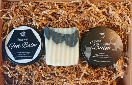 Foot balm and soap set with branded containers on shredded paper
