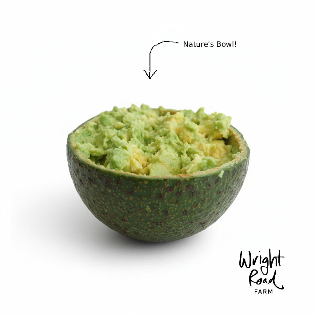 Avocado with mashed interior labeled 'Nature's Bowl' by Wright Road Farm on a white background
